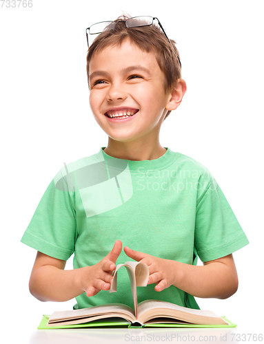 Image of Little boy is reading a book