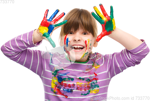 Image of Portrait of a cute girl playing with paints
