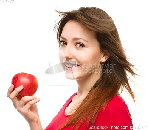 Image of Young happy girl with apple