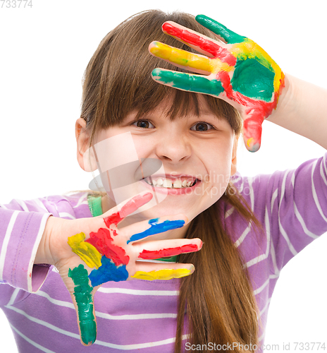 Image of Portrait of a cute girl playing with paints