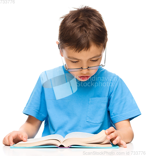 Image of Little boy is reading a book