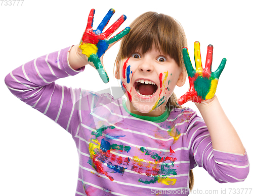 Image of Portrait of a cute girl playing with paints