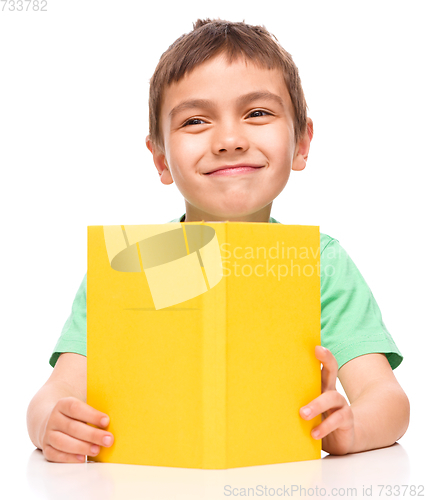 Image of Little boy is reading a book