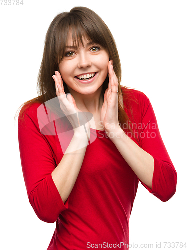 Image of Woman is holding her face in astonishment