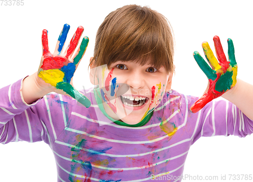 Image of Portrait of a cute girl playing with paints