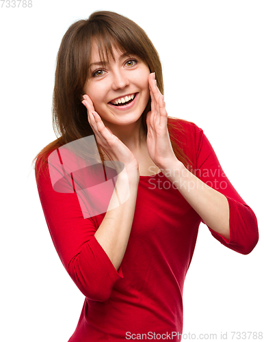 Image of Woman is holding her face in astonishment