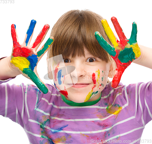 Image of Portrait of a cute girl playing with paints