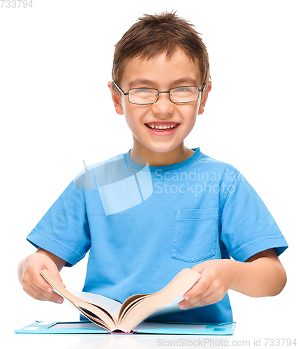 Image of Little boy is reading a book