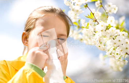 Image of Little girl is blowing her nose