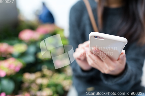 Image of Woman use of cellphone at outdoor