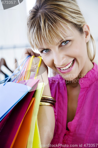 Image of young pretty smiling woman with shopping bags
