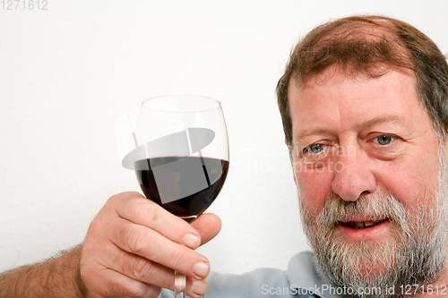 Image of Mature scandinavian man drinking red vine