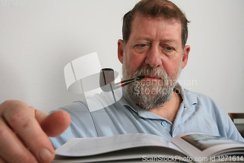 Image of Mature scandinavian man reading a book 