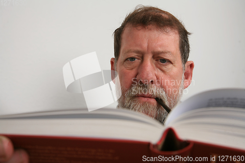 Image of Mature scandinavian man reading a book 