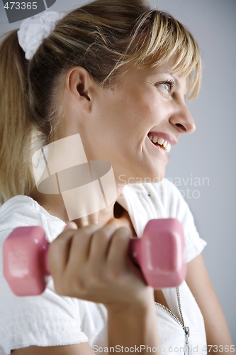 Image of smiling female with dumbell