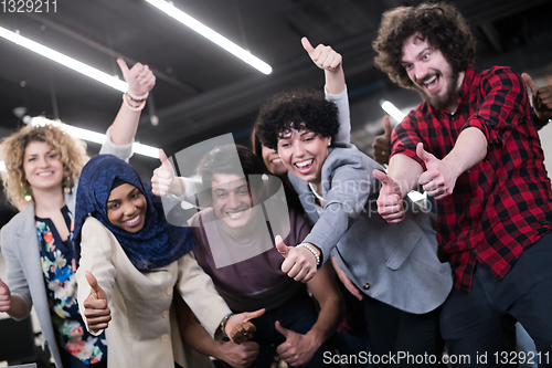 Image of portrait of young excited multiethnics business team