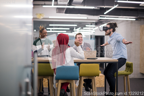 Image of Young Multiethnic Business team using virtual reality headset