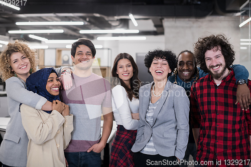 Image of portrait of young excited multiethnics business team