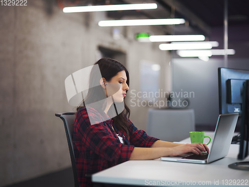 Image of female software developer using laptop computer