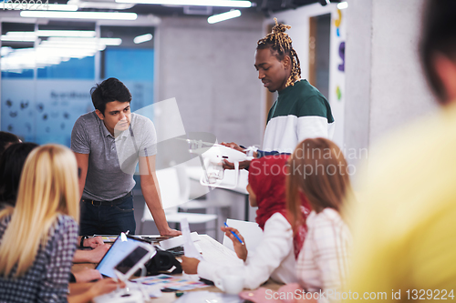 Image of multiethnic business team learning about drone technology