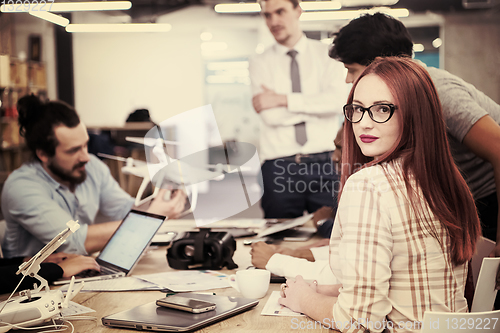 Image of redhead business woman learning about drone technology