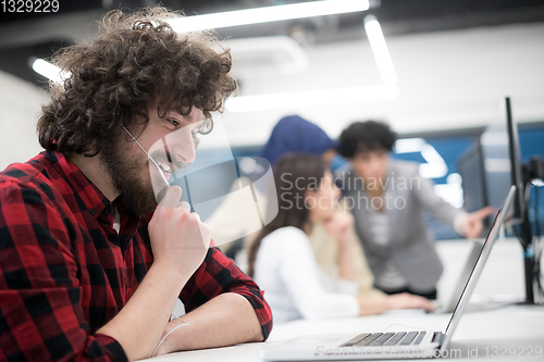 Image of young multiethnics team of software developers working together