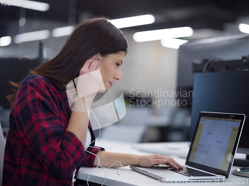 Image of female software developer using laptop computer