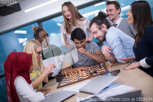 Image of multiethnic group of business people playing chess