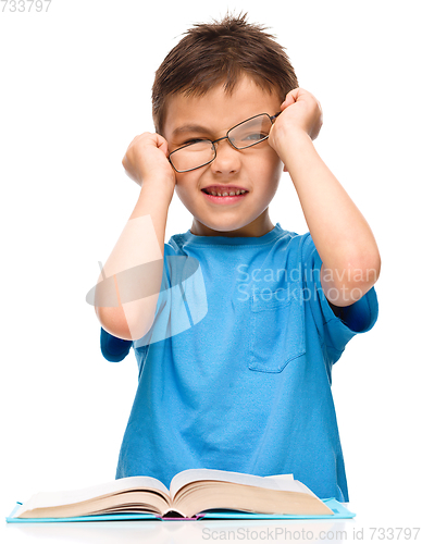 Image of Little boy is reading a book