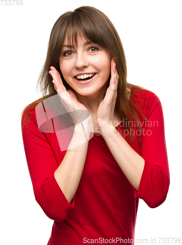 Image of Woman is holding her face in astonishment