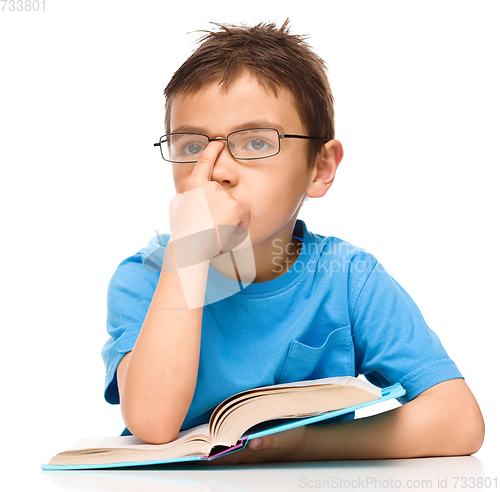 Image of Little boy is reading a book