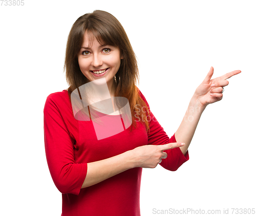 Image of Portrait of a young woman pointing to the right