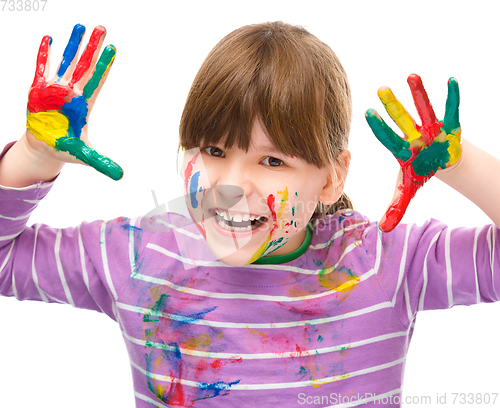 Image of Portrait of a cute girl playing with paints