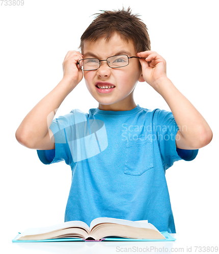 Image of Little boy is reading a book