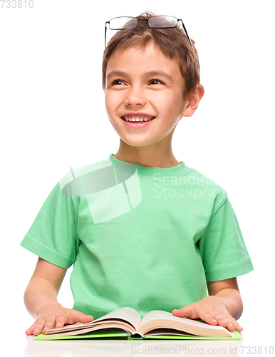 Image of Little boy is reading a book