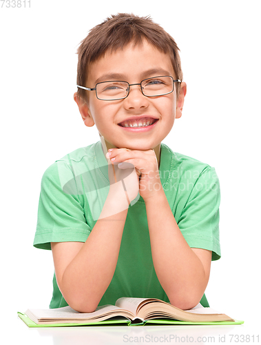 Image of Little boy is reading a book