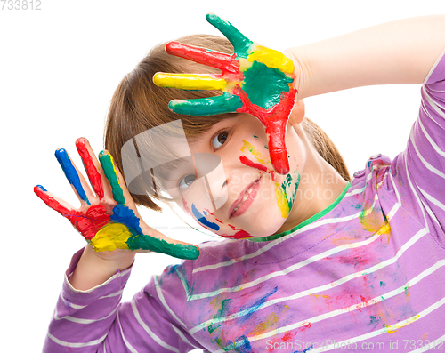 Image of Portrait of a cute girl playing with paints