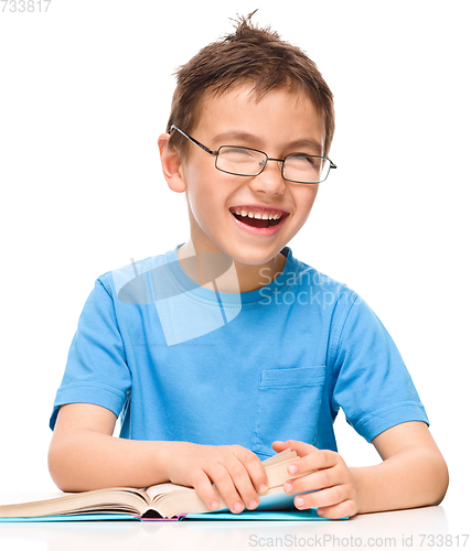 Image of Little boy is reading a book