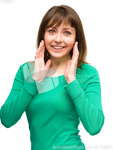 Image of Woman is holding her face in astonishment