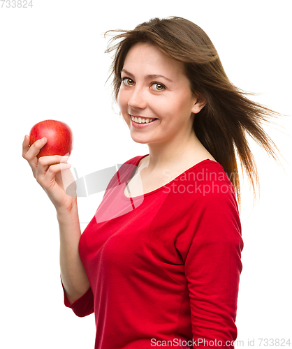 Image of Young happy girl with apple