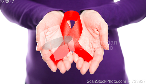 Image of Woman is holding the red awareness ribbon