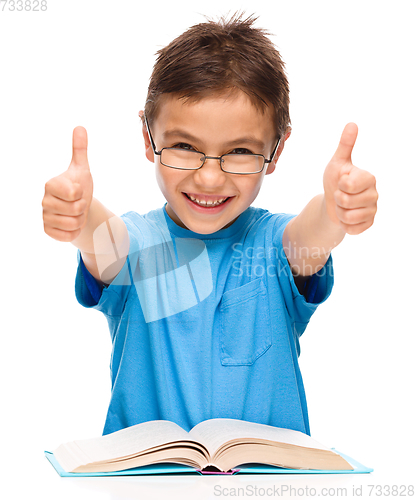Image of Little boy is reading a book