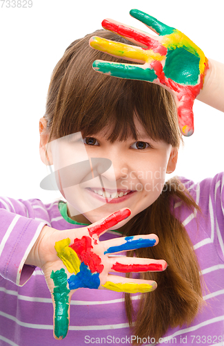 Image of Portrait of a cute girl playing with paints