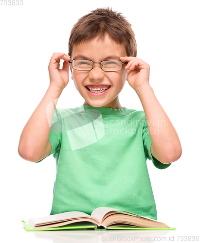 Image of Little boy is reading a book