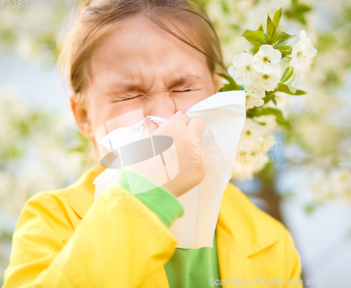 Image of Little girl is blowing her nose