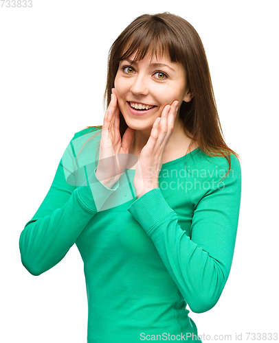 Image of Woman is holding her face in astonishment