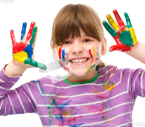 Image of Portrait of a cute girl playing with paints