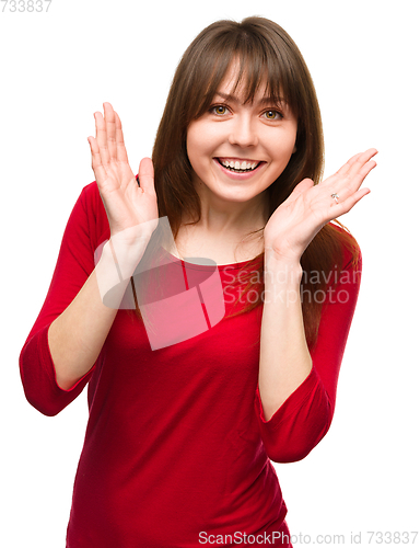 Image of Woman is holding her face in astonishment