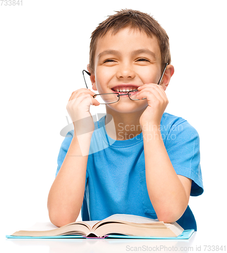 Image of Little boy is reading a book