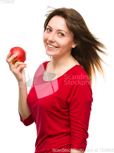 Image of Young happy girl with apple